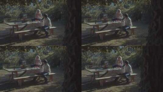 两个人坐在树下野餐高清在线视频素材下载