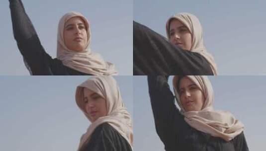 穆斯林女人在蓝天下跳舞高清在线视频素材下载