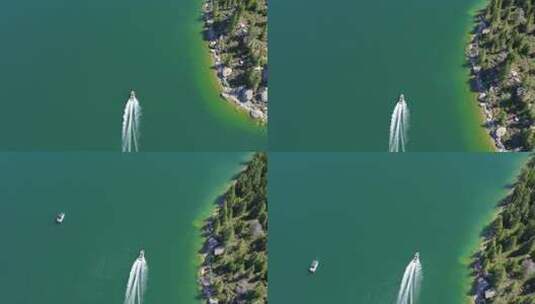 航拍鸟瞰一艘船沿着清澈蓝色湖泊的海岸线行驶高清在线视频素材下载