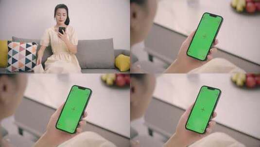 女子坐下点击手机屏幕绿屏跟踪高清在线视频素材下载