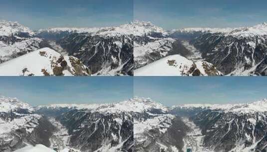 天桥山顶露出后面的山谷。冬天，雪覆盖了瑞士的山脉。高清在线视频素材下载