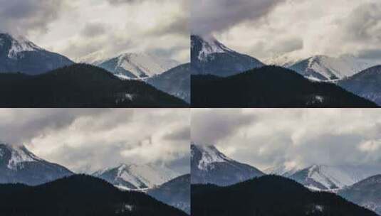 白雪皑皑的高山上戏剧性的云彩高清在线视频素材下载