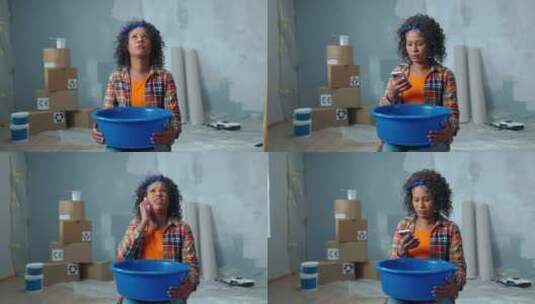 心烦意乱的非裔美国妇女拿着蓝色的碗，水滴从碗里滴下来高清在线视频素材下载