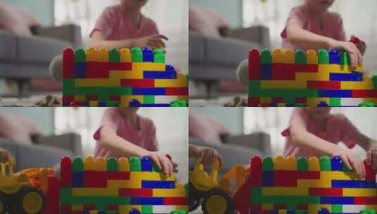 可爱的女孩用彩色塑料块建造结构高清在线视频素材下载