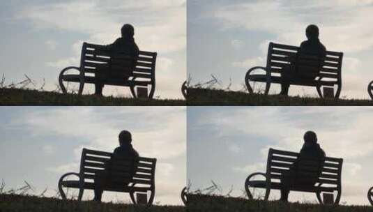 一个老人坐在公园椅子上欣赏远方景色高清在线视频素材下载
