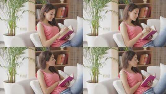 女孩倚在沙发上看书高清在线视频素材下载