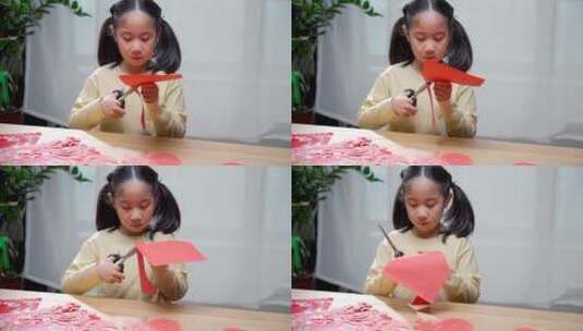 认真玩剪纸游戏的中国女孩高清在线视频素材下载