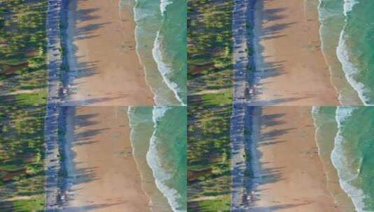 航拍竖版海南万宁日月湾海浪沙滩与公路高清在线视频素材下载