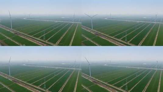 航拍高视角田地间的风力发电涡轮机高清在线视频素材下载