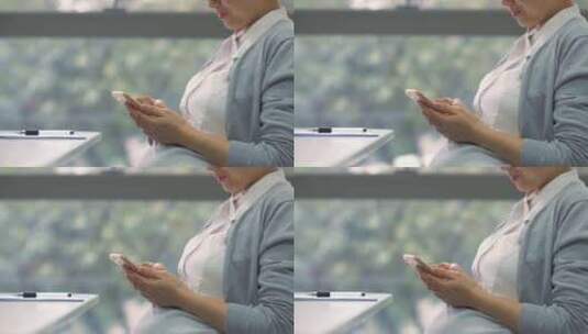 怀孕白领女商人办公室工作看手机特写高清在线视频素材下载