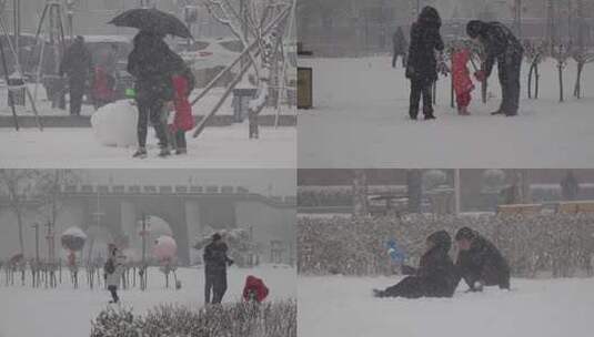 大雪中亲子家庭玩雪打雪仗高清在线视频素材下载