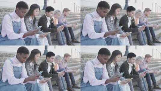 年轻人坐在户外用手机放松高清在线视频素材下载