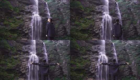 女性人物背影感受亲近自然登顶山峰瀑布水流高清在线视频素材下载