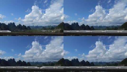 高铁动车列车高铁经过蓝天白云下的山谷乡村高清在线视频素材下载