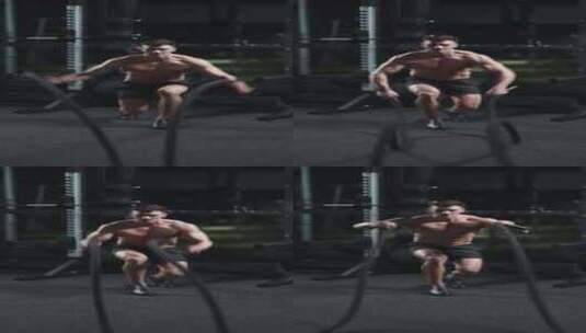 运动男子在健身房电影灯光下用战绳进行耐力高清在线视频素材下载