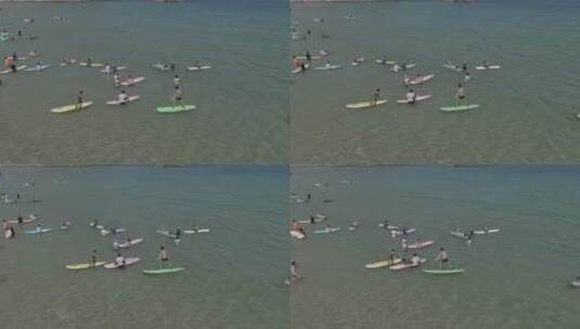 航拍海南三亚后海海滩冲浪游玩高清在线视频素材下载