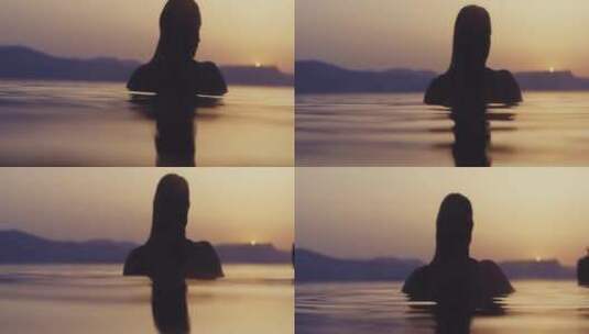 黄昏女人站在海水里高清在线视频素材下载
