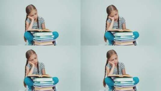 悲伤的女孩坐在地上看书高清在线视频素材下载