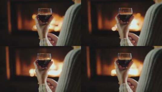 女孩在壁炉前喝红酒高清在线视频素材下载