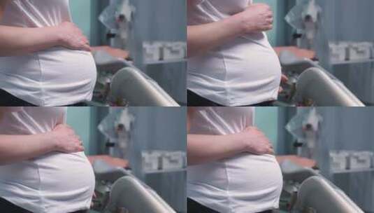 医学会诊中孕妇手触摸腹部的侧视图高清在线视频素材下载