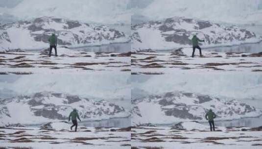 海岸线冰冻荒地徒步旅行的人高清在线视频素材下载