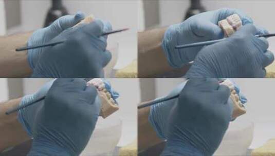 牙科技师用刷子将锆涂层植入腭色高清在线视频素材下载