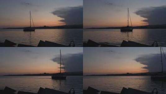 日落时分在海面上行驶的船只剪影高清在线视频素材下载