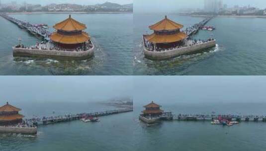 航拍云海下的青岛地标栈桥高清在线视频素材下载