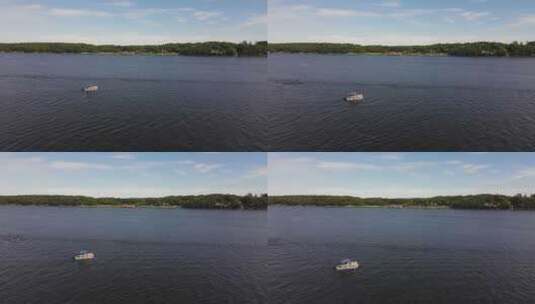 无人机飞越缅因州一艘渡河的游船。飞向陆地高清在线视频素材下载