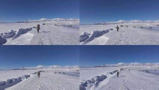 女孩在新疆赛里木湖白雪覆盖的湖面上行走高清在线视频素材下载