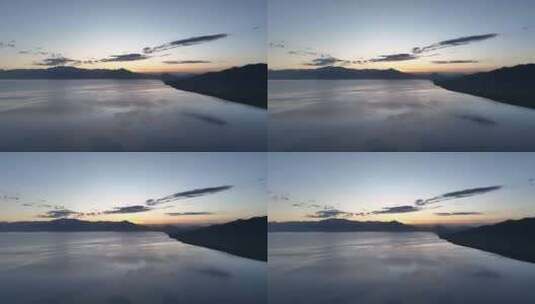 赛里木湖风平浪静的湖面倒映着美丽的朝霞高清在线视频素材下载