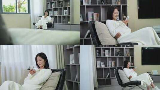 女子居家休闲玩手机高清在线视频素材下载