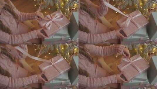 小女孩解开圣诞礼物的蝴蝶结高清在线视频素材下载
