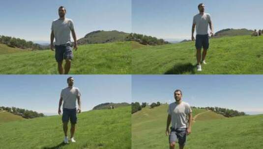 男人行走在绿色的山丘上高清在线视频素材下载
