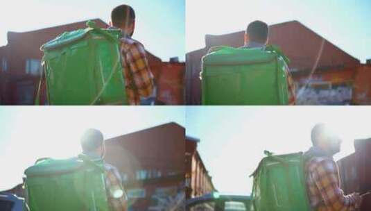 男性送餐员背着背包或绿盒子走在城市街道上的后视图高清在线视频素材下载
