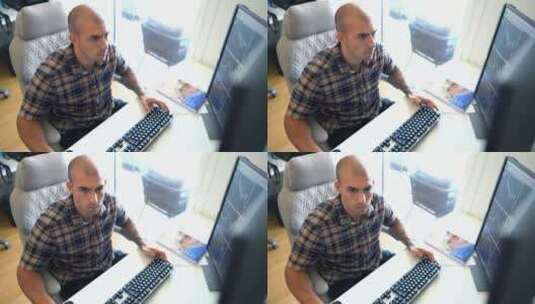 男人坐在电脑前认真工作高清在线视频素材下载