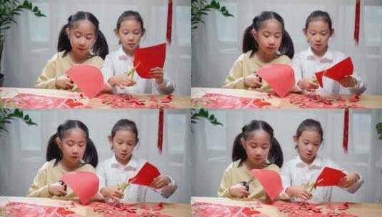 两名认真玩剪纸游戏的中国女孩高清在线视频素材下载