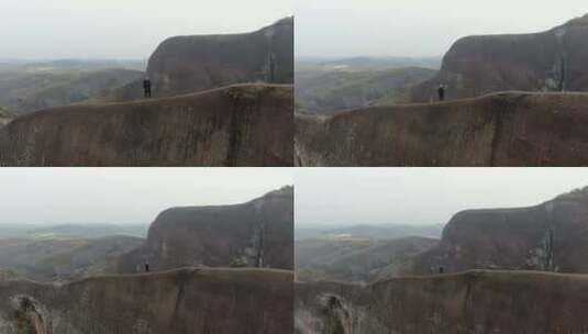 高椅岭刀背山顶无人机航拍男人站在山脊悬崖高清在线视频素材下载