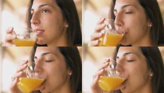 一个年轻黑发女人正在喝一种新鲜健康的饮食高清在线视频素材下载