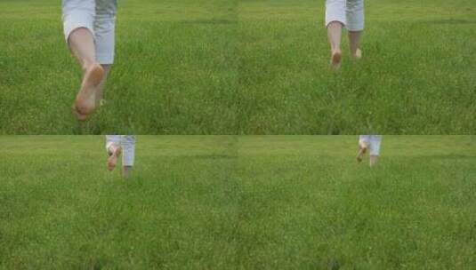 赤脚奔跑在绿色的草地上高清在线视频素材下载