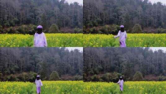 （慢镜）油菜花田地里奔跑的少女背影高清在线视频素材下载