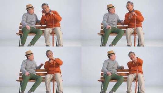 两位老年朋友坐在长椅上聊天高清在线视频素材下载