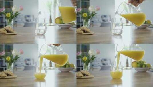 把桌子上的玻璃杯倒满橙汁高清在线视频素材下载