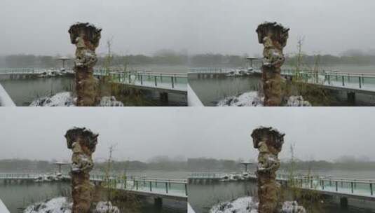 大雪中的北京紫竹院公园湖上的太湖石高清在线视频素材下载
