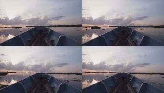 日落时在沼泽地上航行的船高清在线视频素材下载