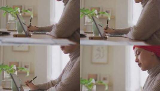 戴头巾的混血儿女人坐在家里的桌子上用平板电脑工作的视频高清在线视频素材下载