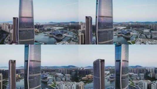 无人机在城市高楼外面环绕镜中反射夕阳高清在线视频素材下载