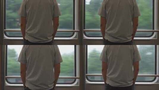 一个男人站在火车上看着窗外高清在线视频素材下载