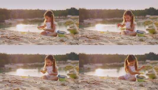 女孩在湖边的沙滩上玩耍高清在线视频素材下载