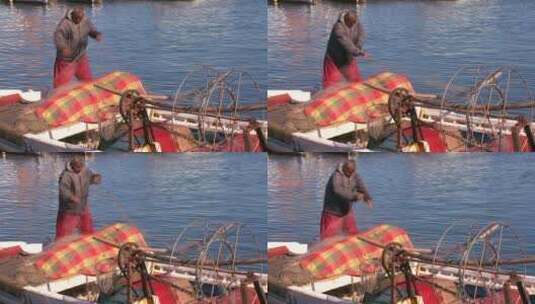 一个渔夫乘着小船在收渔网高清在线视频素材下载